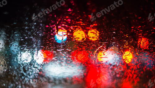Preview: Abstract car lights from a rainy car window