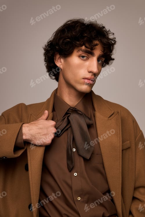 Preview: Stylish man showcases elegance with unique fashion in contemporary studio setting
