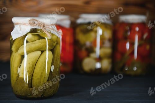 Preview: Glass jars with pickled cucumbers (pickles), pickled tomatoes and cabbage.