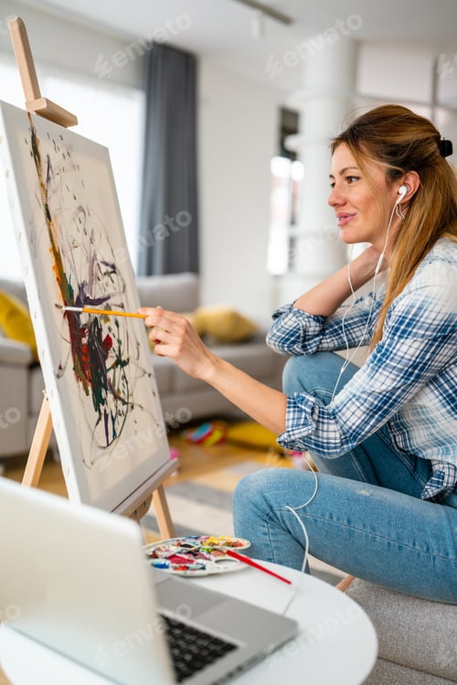 Preview: Art, creativity, hobby, job and creative occupation concept. Woman painting at home