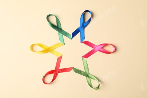 Preview: Flat lay composition with awareness ribbons on color background, space for text.