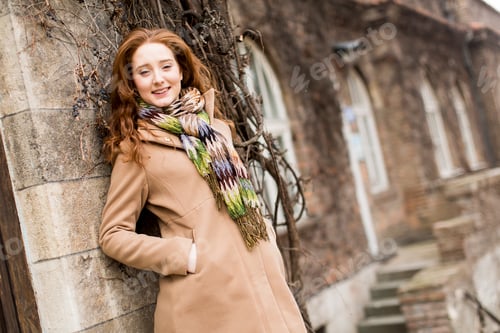 Preview: Young woman by the wall