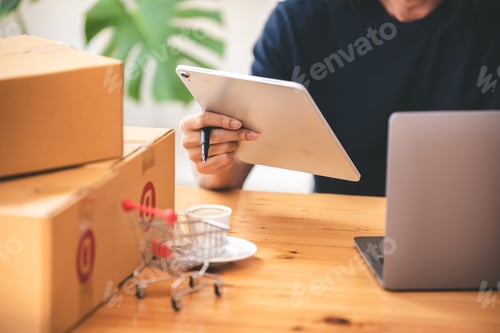 Preview: Small start-up business owners checking parcels at work, freelancers, salespeople, checking producti