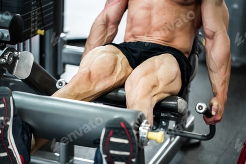 Preview: Gym fitness club indoor with young man training weights with legs.