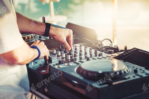 Preview: DJ is mixing music with deejay controller at outdoor summer pool party