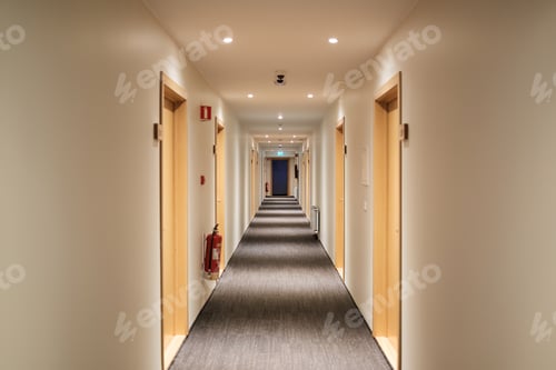 Preview: Emptry hotel corridor with carpet floor, wooden doors, fire extinguisher and emergency exit sign