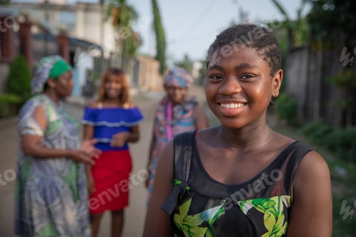 Preview: Portrait of a young African girl with other African women of different ages behind her