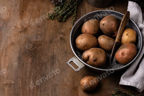 Preview: Raw uncooked potato in old vintage pot