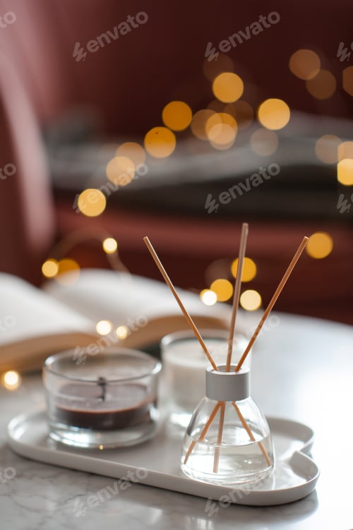 Preview: Liquid home aroma perfume in glass bottle with candle on table