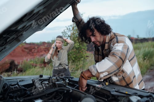 Preview: Bending over open hood of pickup truck