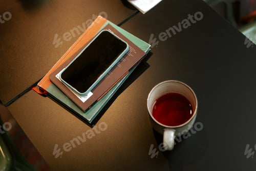 Preview: Black table with smartphone and work accessories top view