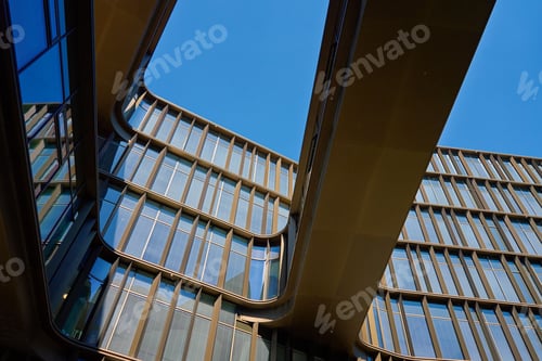 Preview: Abstract view of modern office building againstr blue sky