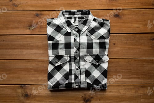 Preview: Folded Black and White Plaid Shirt on Wood