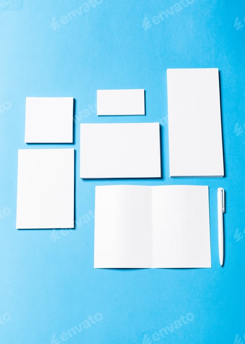 Preview: blank office objects organized for company presentation on blue paper background