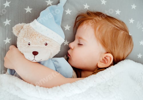 Preview: Little baby girl sleeping with her bear toy.