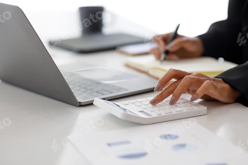 Preview: Close up of businesswoman Accounting using calculating income-expenditure and analyzing real estate