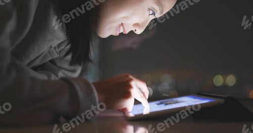 Preview: Woman using tablet computer online shopping at home