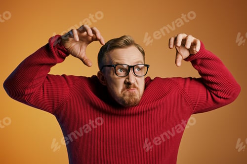 Preview: Stylish Man Strikes Pose in Bold Red Sweater