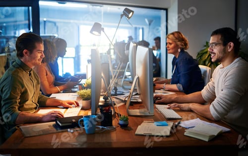 Preview: Shot of a team of young businesspeople working late in the office