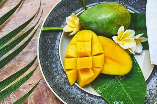 Preview: Fresh mango on a wooden tabel with tropical background. Soft focus.