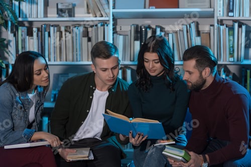 Preview: multicultural students reading book and preparing to exam