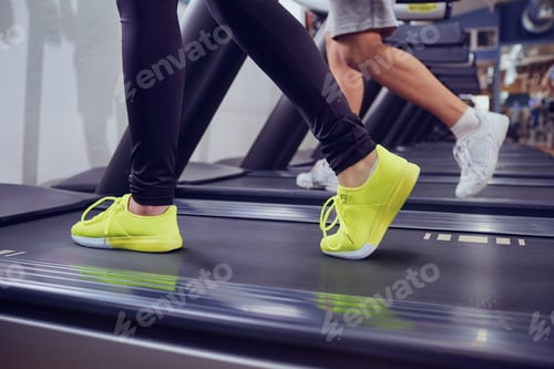 Preview: Detail of female legs on a treadmill in the gym