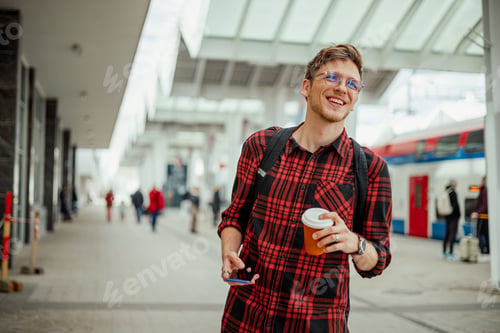 Preview: Portrait of a smiling handsome man standing at the train station or a subway
