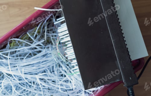 Preview: Shredding papers coming out from the machine. Shredding documents for security