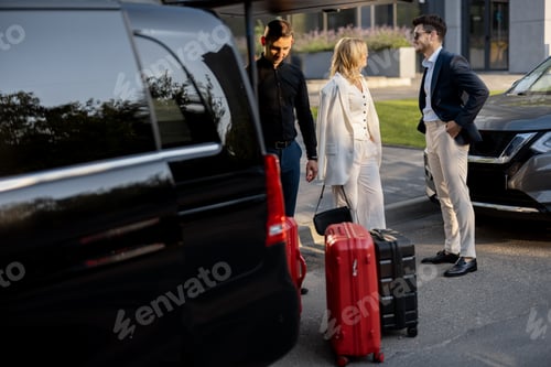 Preview: Business couple near minivan taxi with a suitcases and chauffeur