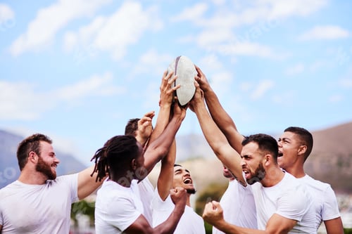 Preview: Shot of a group of young rugby players raising a rugby ball in solidarity at a game