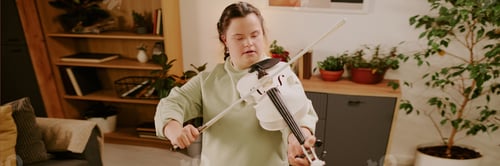 Preview: Young Woman With Disability Playing Violin In Living Room Header