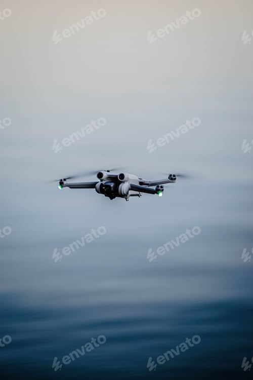 Preview: Small drone hovering above the surface of a still lake