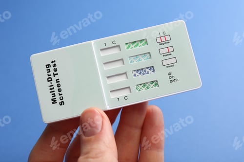 Preview: Woman holding multi-drug screen test on blue background, closeup