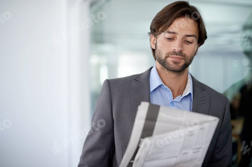 Preview: The business section. A young businessman reading a newspaper in the office.
