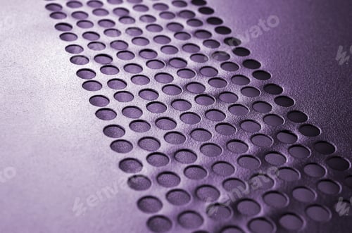 Preview: Black metal computer case panel mesh with holes on purple background. Abstract close up