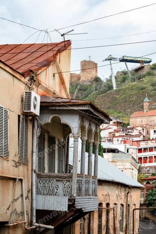 Preview: shabby house with carved balcony in old Tbilisi