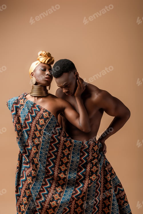 Preview: sexy naked tribal afro woman covered in blanket posing near man on beige