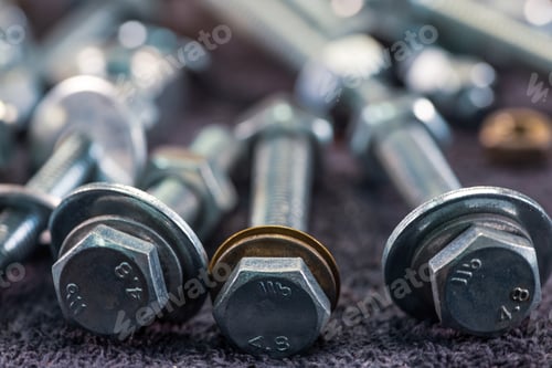 Preview: Metal chrome bolts and nuts in a chaotic order industrial background