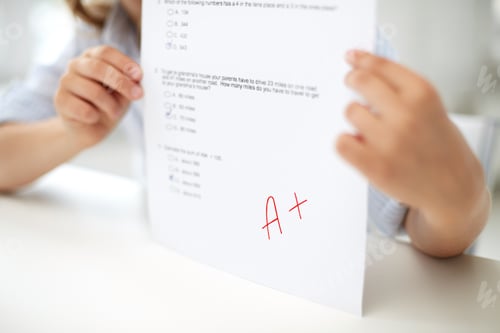 Preview: girl with test paper at school