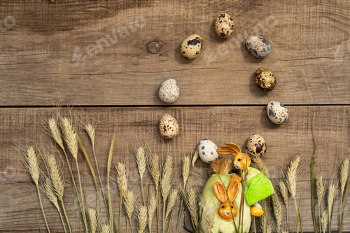 Preview: quail eggs and ears of rye or wheat on a wooden background