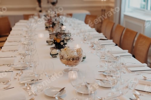 Preview: Banquet hall of restaurant with dining table beautifully decorated with glassware and dishes