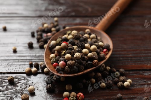 Preview: Aromatic spice. Different peppers in spoon on black table, closeup