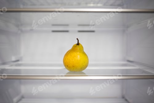 Preview: Fruit pear on a shelf in an empty white refrigerator