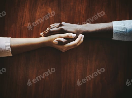Preview: Youll always have someone who cares. High angle shot of two people holding hands in comfort.