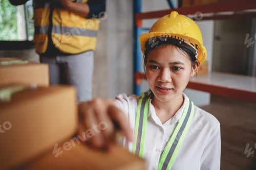 Preview: Asian female supervisor checking a warehouse check inventory and inspect the goods to check