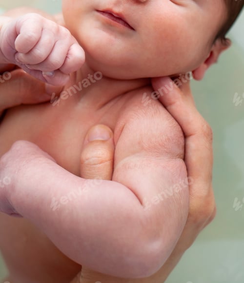 Preview: Newborn Infant Held Gently in Caring Hands