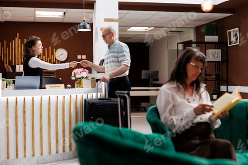 Preview: Elderly traveler obtains hotel key card
