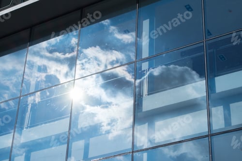 Preview: Sun ray and blue sky reflection on window office building, Business concept