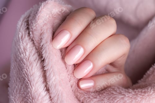 Preview: Hand in sweater with nude nails on pink textile background