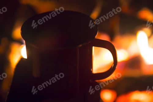 Preview: Retro Metal Cup with Fresh Black Coffee Against Beautiful Camp Fire